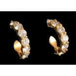 A pair of Diamond Earrings each peg-set a line of seven brilliant-cut stones in 18ct gold