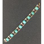 An Egyptian revival faience scarab and enamel Bracelet, composed of eight turquoise coloured scarabs