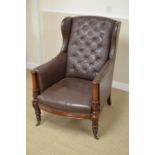 A 19th Century mahogany Library Chair upholstered in button down leather, the wing back and swept