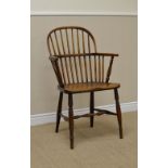 A 19th Century Windsor Elbow Chair in ash and elm with stick back, solid seat on turned legs