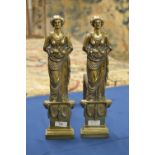 A pair of antique brass Andirons in the form of female figures of 'Plenty', with ram's head and swag