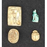 Two Egyptian Seals, a Bast Amulet and a Scarab; the first an 18th Dynasty panel seal with various