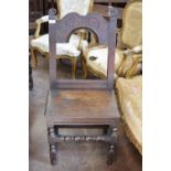 A 17th Century oak Derbyshire Side Chair with floral carved top rail, solid seat on turned and