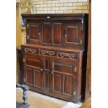 An 18th Century oak Court Cupboard with pair of small fielded panelled doors fronted by turned