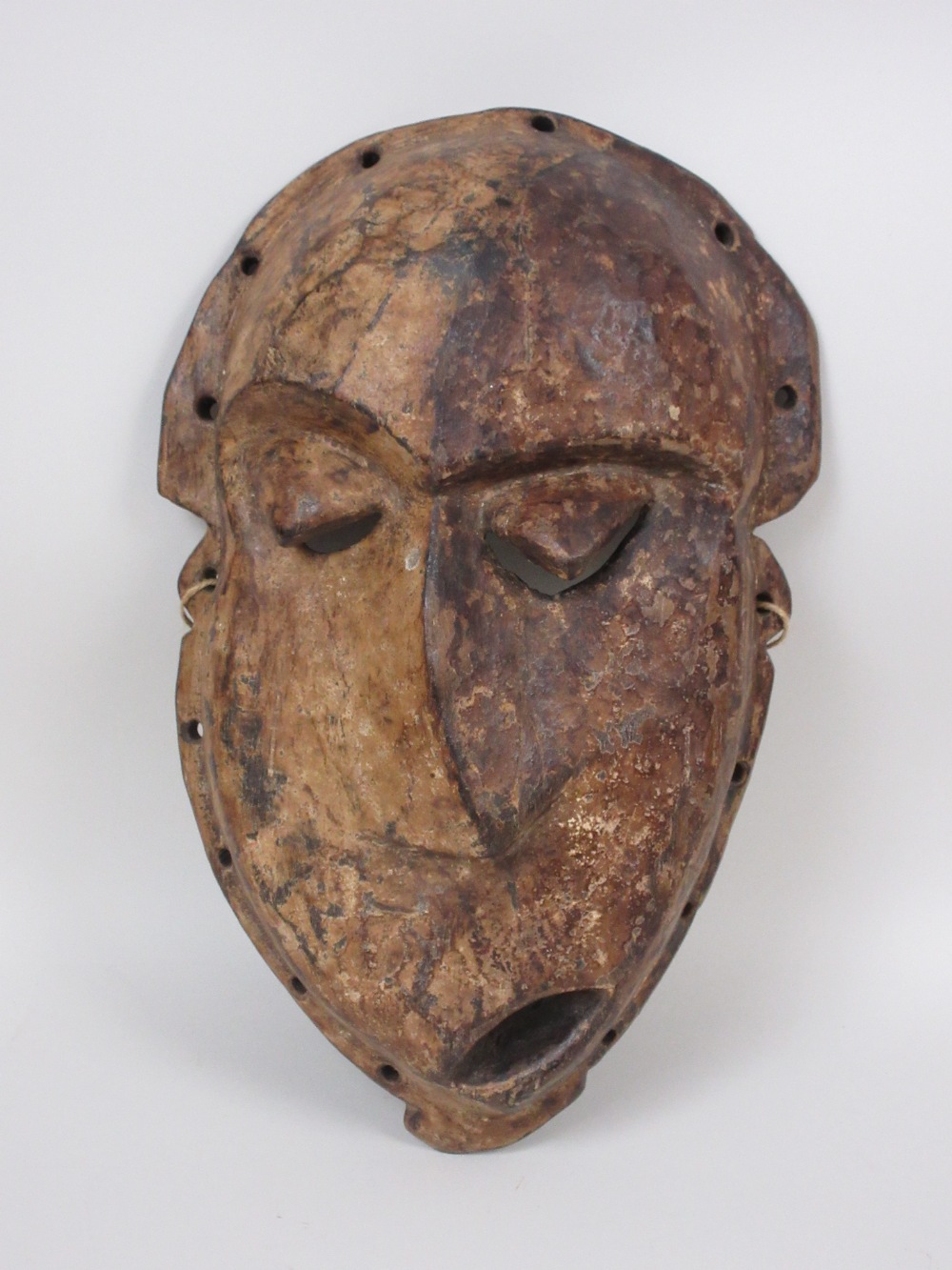 A Pende "Kwese" Mask, wood with dark and light pigment, Congo