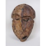 A Pende "Kwese" Mask, wood with dark and light pigment, Congo