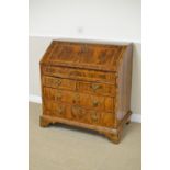 An 18th Century inlaid walnut Bureau, the quartered fall enclosing a stepped interior with well,