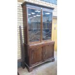 A Georgian mahogany Bookcase with dentil cornice above a pair of astragal glazed doors, the base