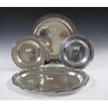 An Indian silver oval Platter, circular Platter and a pair of Salvers