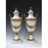 A pair of white marble and gilt metal Urns with mask handles and square bases, 20in H