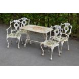 A white painted cast iron Garden Table and four Chairs with scroll designs