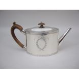 A George III silver oval Teapot with laurel wreath and ribbon vacant cartouche, London 1787, makers: