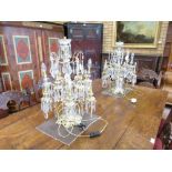 A pair of brass twelve branch Table Centrepieces with cut glass droppers, fitted for electricity,