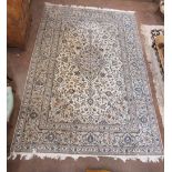 A Persian style Carpet multi-bordered with floral motifs on a cream ground, 11ft 6in x 7ft 11in