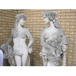 A pair of large Garden Figures of Classical Maidens with bunches of grapes and sheaf of corn on