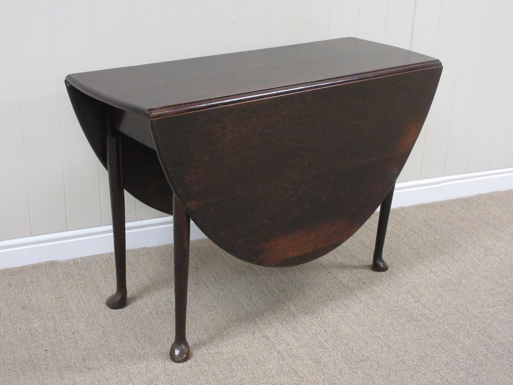 An 18th Century oak oval Dropleaf Table on turned tapering legs and pad feet, 3ft 7in x 4ft 8in