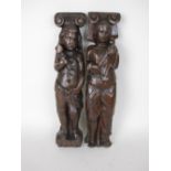 Two 17th Century carved oak Pilasters of standing figures with mallet and staff, 16in