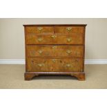 An 18th Century walnut Chest of Drawers, the moulded quartered cross-banded top with a central