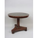 An apprentice made rosewood Table with leather inset top on octagonal column and triform base 13 1/