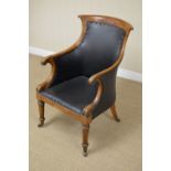 A 19th Century Library Bergere Chair, the shaped top rail and swept arms on carved supports above