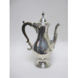 A George III silver Coffee Pot of baluster form, the domed lid with urn finial, ornate spout, scroll