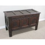 A 17th Century oak Coffer with sunken four panel lid above arch carved frieze and three star