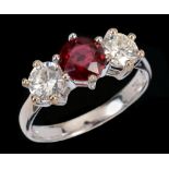 A Ruby and Diamond three stone Ring claw-set unheated round ruby, 1.18cts, between two brilliant-cut