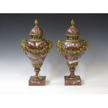 A pair of rouge marble Urns with gilt metal ram's head masks on square bases, 16in H