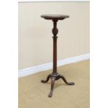 A Georgian mahogany Kettle Stand with dished circular top on gun barrel turned column and tripod