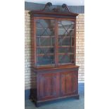 A 19th Century mahogany and astragal glazed two door Bookcase with pierced swan neck pediment