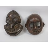 A Hemba Monkey Mask, wood, Congo, and a Mask with brown pigment and inserted bristles, probably