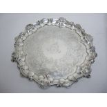 A Victorian silver shaped circular Salver with floral scroll engraving, coat of arms, scallop border