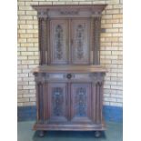 A 19th Century walnut Buffet fitted two pairs of panelled cupboard doors with carved floral and mask