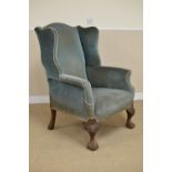 A Georgian style mahogany Wing Armchair with blue dralon upholtery on scroll and scallop carved