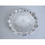 A Victorian silver shaped circular Salver with floral and scroll engraving, initial B, scroll border