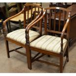 A pair of Georgian mahogany Elbow Chairs with reeded rail backs, upholstered drop-in seats on square