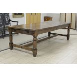 A 17th Century style massive oak Dining Table with thick six plank top on turned and square supports