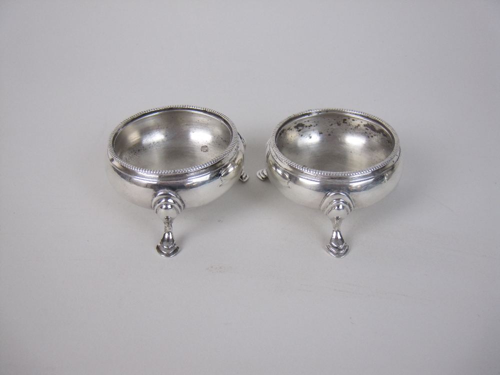 A pair of George III silver Cauldron Salts with beaded rims on hoof feet, London 1783