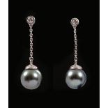 A pair of Diamond and Grey Cultured Pearl Earrings each rub over-set single brilliant-cut diamond