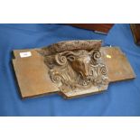 An 18th Century French oak Misericord, carved bull's head and scroll decoration