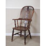 An antique yew and elm Windsor Elbow Chair with pierced splat back, shaped arms on baluster turned