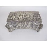 A Continental silver Casket embossed with figures merrymaking, cast figure musicians to the corners,