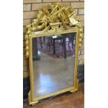 A 19th Century gilt framed Wall Mirror with ornate surmount, 27 x 48in