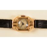 A Lady's manual Cocktail Watch the textured dial with arabic numerals in tonneau shaped 18ct gold