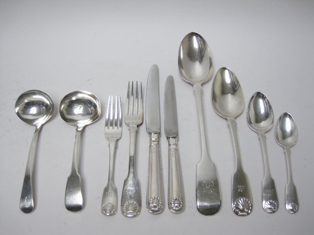 A matched set of silver Cutlery for twelve, fiddle and shell pattern, mostly engraved initial M,