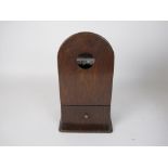 An unusual antique oak Salt Box with watch holder in the arched surmount, drawer to base, 12in