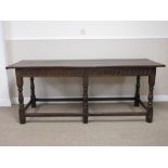 An antique oak Serving Table with carved frieze on baluster turned supports and later top, 6ft 2in L