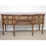 A George III mahogany breakfront Sideboard fitted four drawers and cupboard door on turned