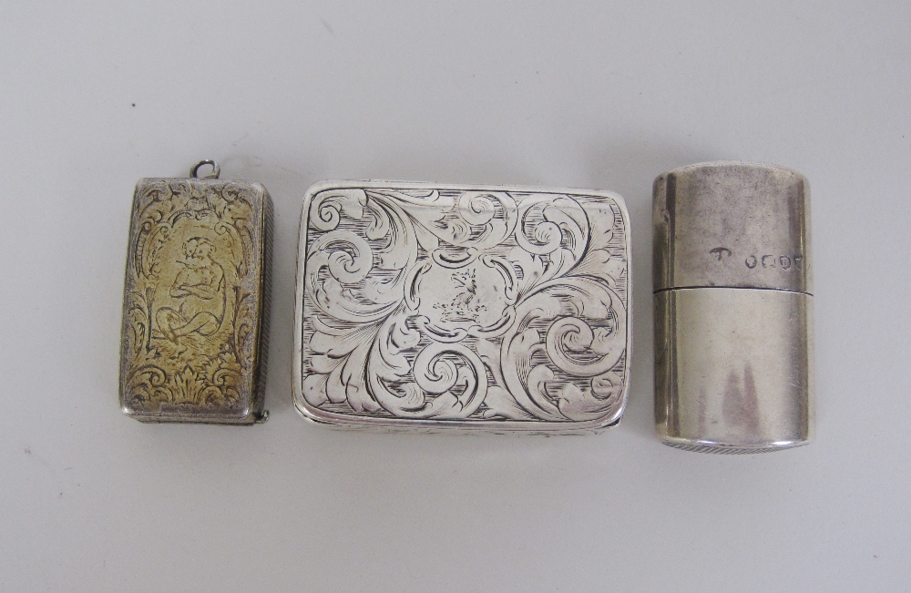 A Victorian silver oval Vesta Case, London 1879, a silver-gilt rectangular Vesta Case engraved