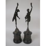 A pair of bronzed Figures of Mercury and companion, standing on masks and circular bases, 20in